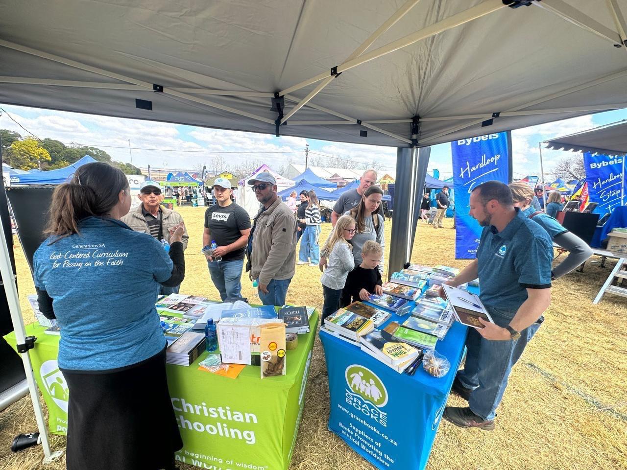 Visitors browsing Generations curriculum and Grace Books titles at the Kragdag stand, August 2025